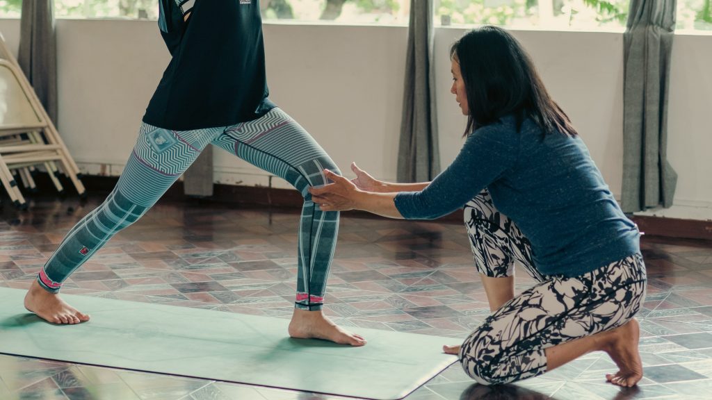 Couple Wellness Day: Instructor correcting Yoga poses